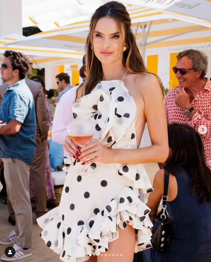 Victoria's Secret model Alessandra Ambrosio looks hot in an elegant cocktail dress with polka dots and ruffles as she attended the Veuve Clicquot Polo Classic in California.