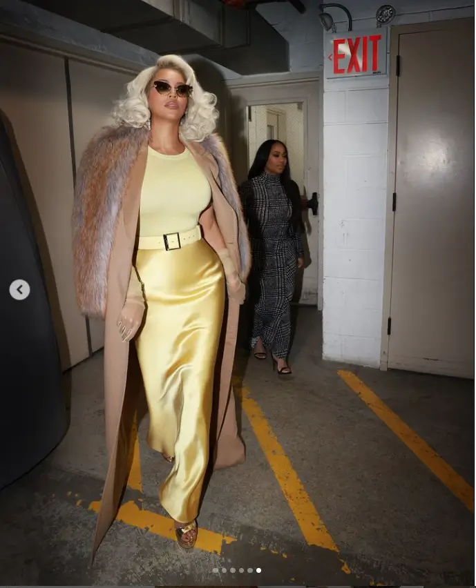 In behind-the-scenes shots of Beyonce, she oozes elegance in a figure-hugging lemon yellow top and satin skirt