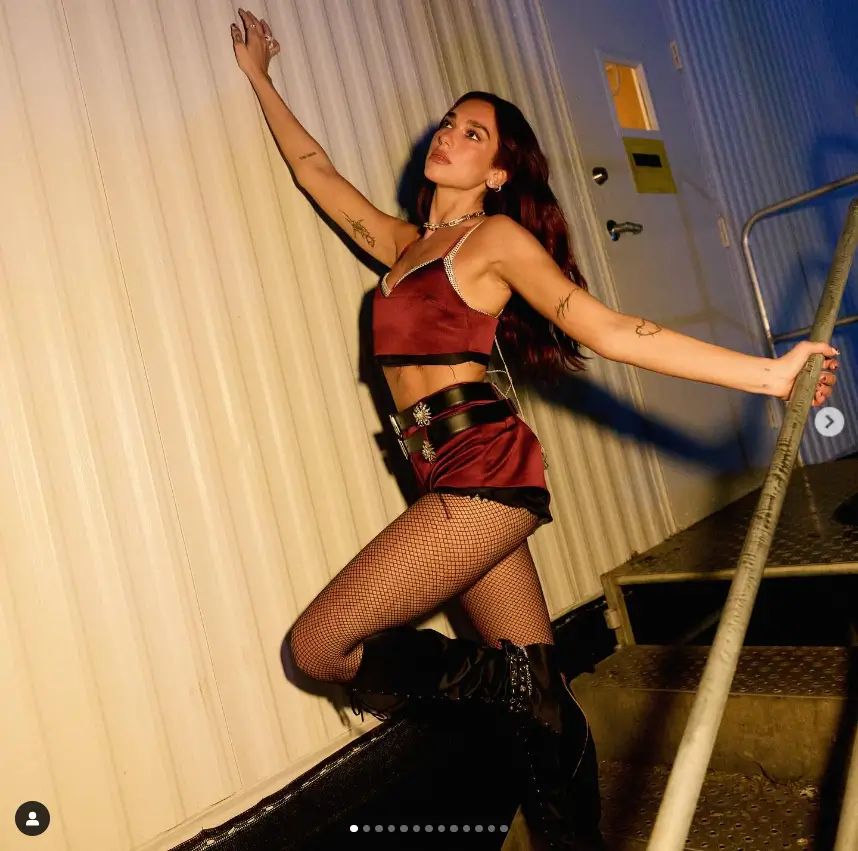 As she hit the stage for her headlining performance, she was dressed in burgundy shorts and a crop top, paired with black leather knee-high boots, and looking very stylish.