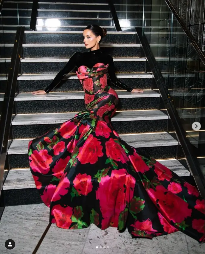 A floral print black dress with a flowing train and a pink floral print adorned Maura Higgins' appearance on the red carpet at the National Television Awards at The 02 London.