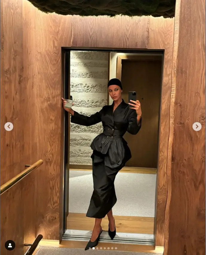 Maya Jama looks elegant and sophisticated in a black satin blazer and matching maxi skirt