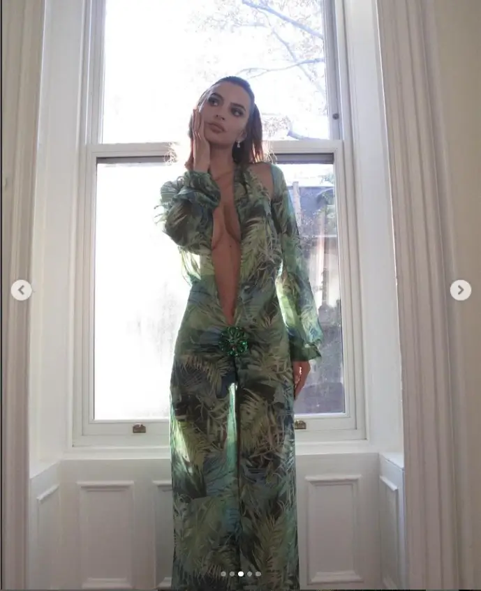 Taking photos indoors and near windows, Emily wore an almost identical dress, selecting long sleeves, figure-hugging cuts, and flimsy silk fabrics covered in multi-toned prints.