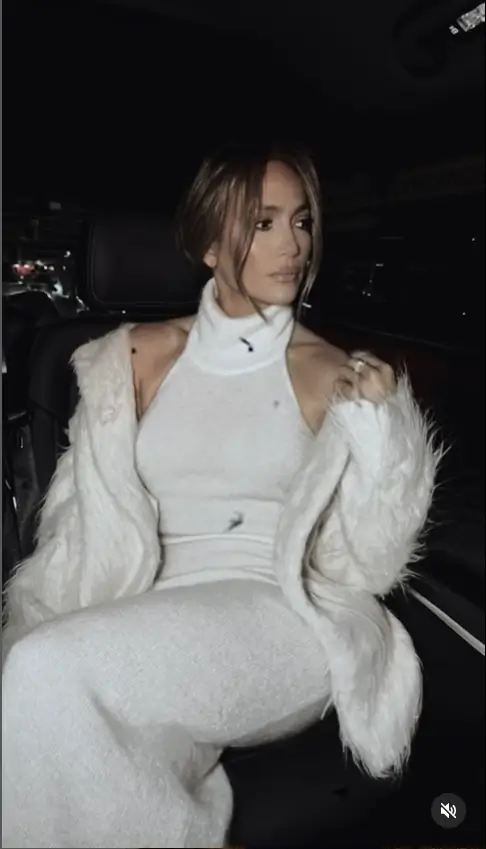 Jennifer Lopez showcased her stunning figure  in a white knitted turtleneck dress paired with a white mohair oversized coat