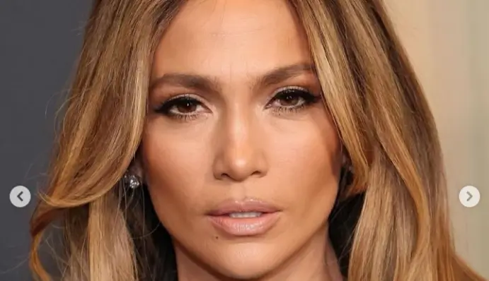 Jennifer Lopez looks stunning in a sheer beaded silver metallic gown that elegantly showcased her toned figure at star-studded event