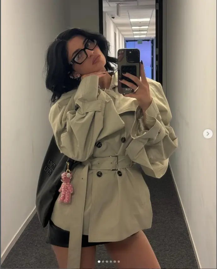 As Kylie Jenner emerged Saturday morning in her hometown of Calabasas, California, she wore an eye-catching beige Miu Miu trench coat.