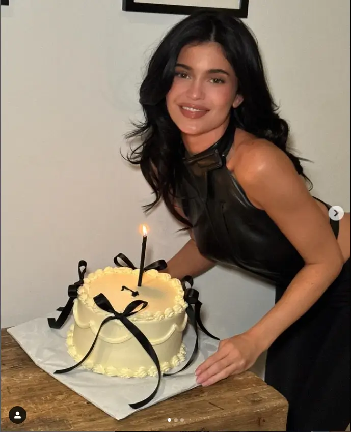 Kylie Jenner shared an Instagram post on Friday commemorating the one year anniversary of her clothing line Khy with a gorgeous yellow cake decorated with four black ribbons and one black candle.