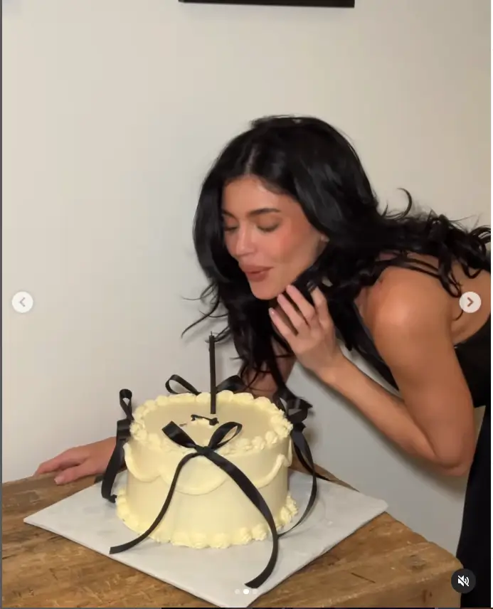 In her cover photo, she is seen leaning over her cake with her raven tresses flowing down long and adding volume with natural waves.