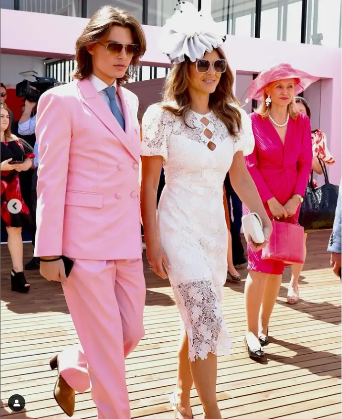 She seemed to be in a good mood as she posed alongside Damian, who looked dapper in a pastel pink two-piece suit, which he paired with a white shirt and a washed-out blue tie.