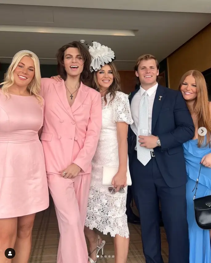 Liz Hurley looked elegant in a white lace gown with keyhole cut-outs at the neckline as she attended Crown Oaks Day