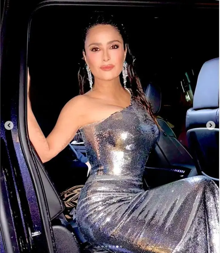 Salma Hayek flaunted her killer figure in a striking metallic silver dress that looked like it was painted on