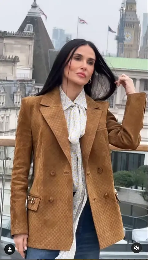 Demi Moore shows off her ageless complexion as she stepped out in a tan jacket over a sheer daisy print shirt