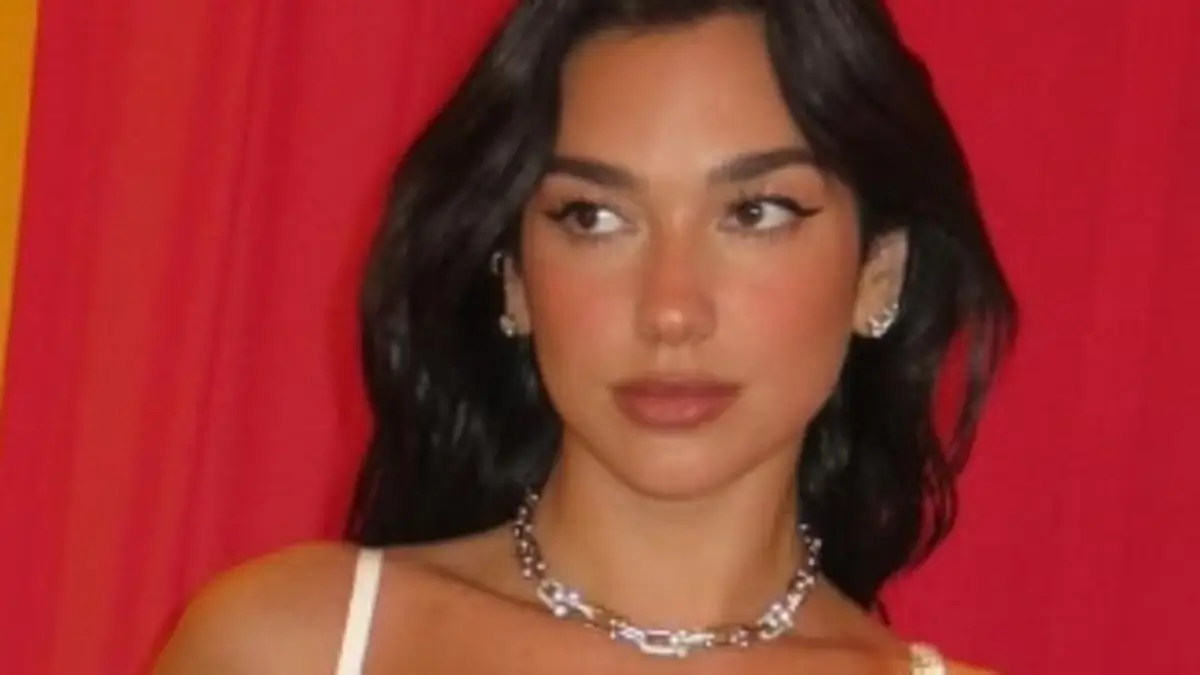 Dua Lipa flaunts her stunning physique in a bedazzling white leotard as ...