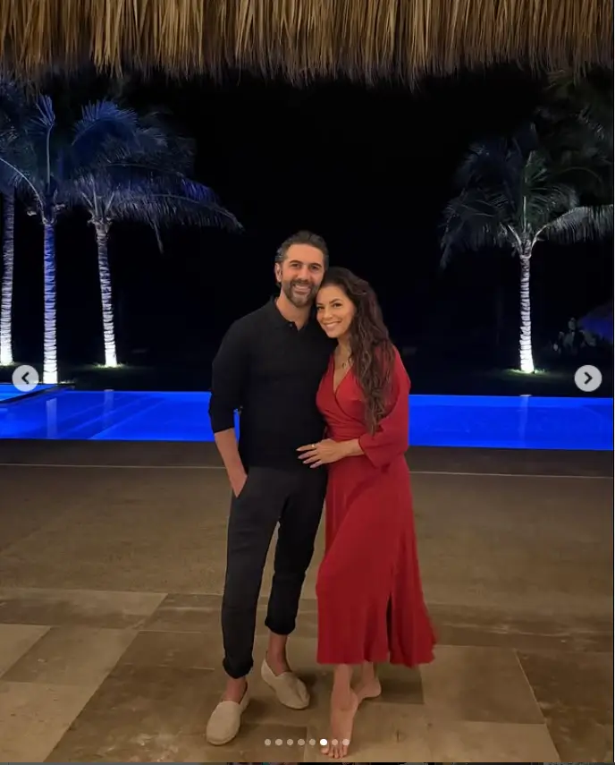 Eva looked cozy as she snuggled next to her handsome husband by the pool in another snap. Donning a vibrant red midi dress, she effortlessly styled her dark locks cascading down her shoulders, adding to the overall romantic vibe.