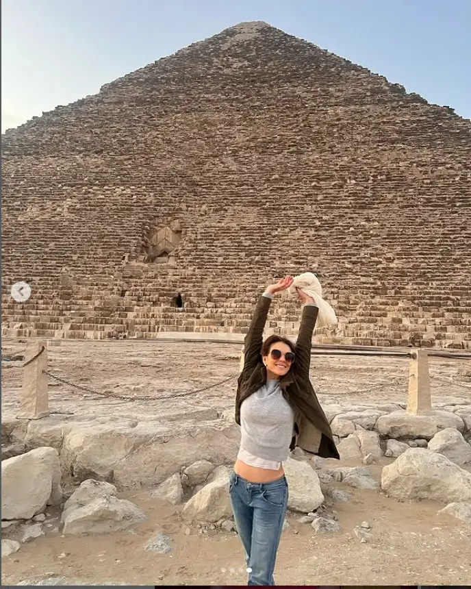 On Instagram, the 59-year-old actress struck a playful pose in front of the Giza pyramids and gave a glimpse of her well-defined abs as she threw her arms in the air.