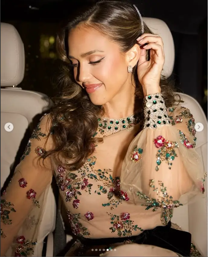 The star's ensemble was adorned with a sheer overlay, expertly adorned with dazzling details and cinched at the waist with a black velvet bow for a flawless finish.