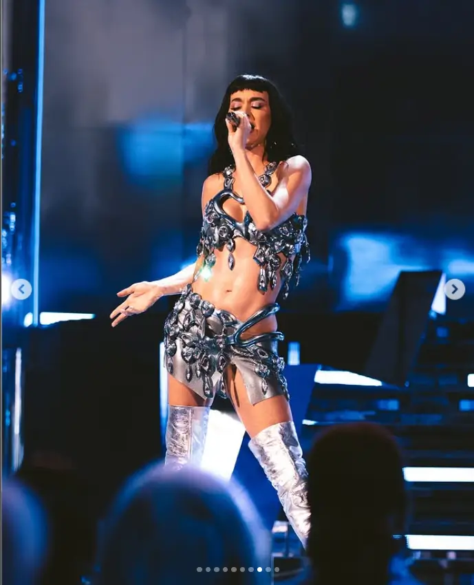 For her next look, Katy showcased her toned abs in in a silver outfit, complete with a sparkling mini skirt and revealing bejeweled bralet.