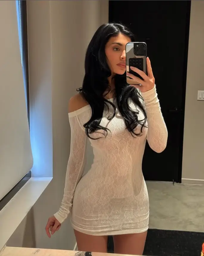 In her latest Instagram post, Kylie Jenner once again captured attention as she flaunted her incredible curves in a form-fitting white lace dress.