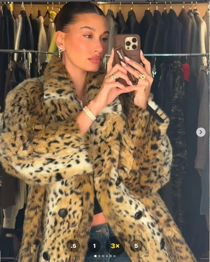 Hailey Bieber showed off her toned abs and cleavage as she stepped out in a stylish furry leopard print coat