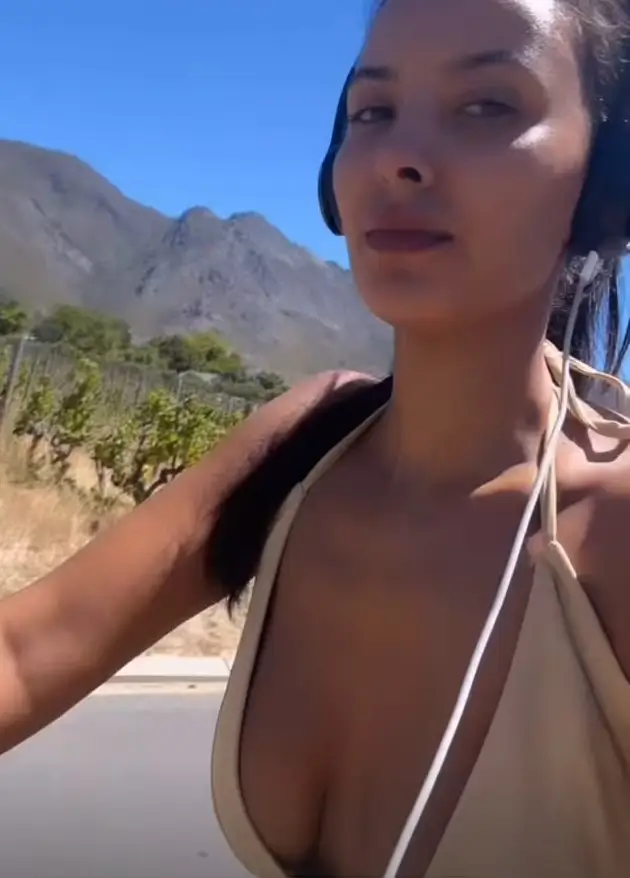 During her bike ride in South Africa on Thursday, Maya Jama stunned in a plunging beige dress as she captured the moment on Instagram