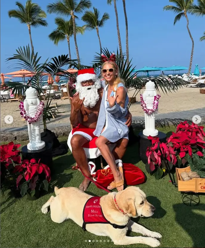 Additionally, she posted a humorous snapshot of a topless, shorts-wearing Santa Claus playing on the beach with his 'reindeer' - a yellow lab. In the photo, she can be seen sitting on Santa's lap as they both flash the hang ten hand sign.