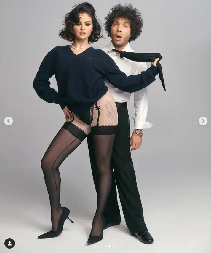 Selena and Benny playfully posed for the camera in their stylish outfits, with Selena even grabbing onto Benny's tie as he reacted in shock. Her impeccable fashion sense was on full display in a black dress with a daring neckline, topped off with a cozy brown jacket.